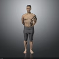 Shirtless Man Standing with Hands Behind Back in Gray Tight Pants on Gray Background