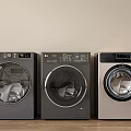 Three Modern Washing Machines With Round Doors And Control Panels On Wooden Floor