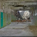 Abandoned Corridor With Peeling Paint Graffiti And Debris On Floor