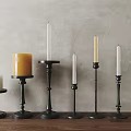 Modern Black Metal Candle Holders With Various Heights On Wooden Tabletop Against Gray Wall