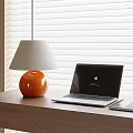 Orange Base Gray Shade Table Lamp with Laptop on Wooden Desk by White Blinds