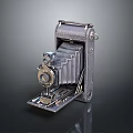 Vintage Folding Camera With Leather Cover Metal Body And Retro Design