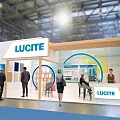 Modern LUCITE Exhibition Booth With Open Structure Green Plants And Visitor Displays