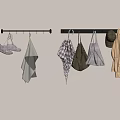 Various Kitchen Aprons And Towels Hanging On Wooden Hooks Against Beige Wall