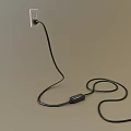 Black Cable Plugged Into Power Outlet On White Background With Coiled Wire On Floor