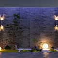 Tranquil Courtyard Garden Featuring Gray Stone Wall Wall Lights Trees Round Lights And Mossy Grass