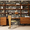 Wooden Desk With Bookshelf Drawers Chair And Decorative Books Against Floral Pattern Wallpaper