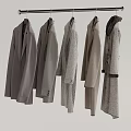 Six Different Styles of Gray Coats Hanging on Metal Hanger Light Background