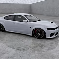 White Sporty Sedan With Sleek Exterior And Black Alloy Wheels In Modern Indoor Studio
