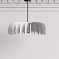 Scalloped Modern Chandelier Hanging Over White Wall With Decorative Crown Molding