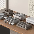 Soft Gray and Brown Towels Folded and Rolled on Wooden Table with Trays