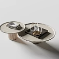 Nested Round Coffee Tables with Light Gray Top Ribbed Gold Base Glass Cups and Magazine