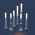 Elegant Lit Decorative Candles With Transparent Glass Bases Spiral And Conical Shapes For Home Decor