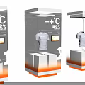 Corporate Exhibition Hall with Transparent Display Cases Featuring White T-Shirts Digital Screens and Orange Bases