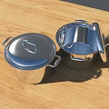 Shiny Stainless Steel Cooking Pots With Open And Closed Lids On Wooden Countertop