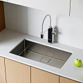 Stainless Steel Kitchen Sink With Black Faucet On White Countertop And Light Wooden Cabinets