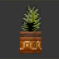 Pixelated Green Plant In Orange Geometric Patterned Pot With Black Background Reflection