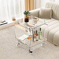 Transparent Acrylic Coffee Table With Wheels Vase Coffee Cup And Wine Bottles On Lower Shelf