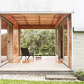Modern Detached Villa With Large Glass Windows Lawn And Surrounding Trees