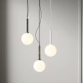 Three Modern Pendant Lights with Round Globe Shades and Metal Rods in Minimalist Interior