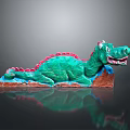 Vibrant Green Dragon Sculpture With Red Accents Lying On Brown Base Artistic