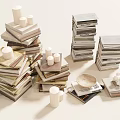 Neatly Stacked Books And Magazines With White Candles And Decorative Plates