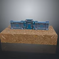 Blue Metal Gate Featuring Intricate Decorative Details On Wooden Display Base