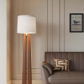 Cozy Living Room With Wooden Floor Lamp White Shade Brown Sofa And Geometric Pillow