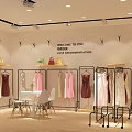 Modern Clothing Store Interior With Organized Racks Display Tables And Decorative Plants