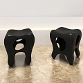 Unique Black Stools with Hollow Seat and Curved Legs on Marble Floor