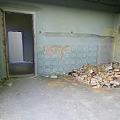 Unfinished Room Interior With Peeling Walls Tile Wall And Construction Debris