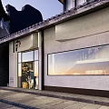 Traditional Chinese Storefront In Evening Featuring Wooden Panels Large Glass Windows And Eaves