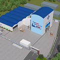 Industrial Factory Building With Blue Roof Surrounded by Green Trees and Operational Vehicles