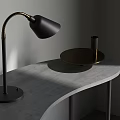 Black Desk Lamp With Golden Curved Arm Modern Design On Gray Curved Tabletop