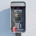 Public Phone Booth With Graffiti And Coca Cola Cup On Gray Wall