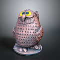 Decorative Brown Pink Owl Sculpture With Yellow Eyes Perforated Body And Gray Base
