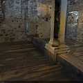 Medieval Interior Featuring Stone Walls Wooden Staircase Pillar And Hardwood Floor