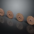 Copper Colored Hardware Tool Gears With Toothed Edges Arranged On Black Background With Reflections