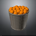 Grey Woven Basket Filled With Round Orange Decorative Balls On Dark Surface