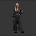 Blonde Woman in Gray Blazer and Wide Leg Pants with Brown Shoes Against Gray Background