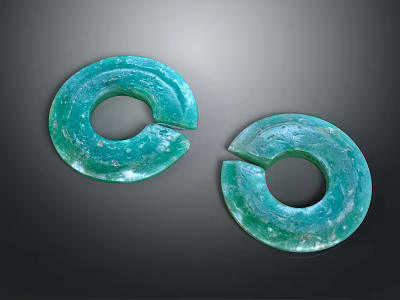 Two Green Notched Circular Artifacts With Blue Green Surface Patterns 3d model