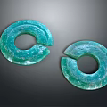 Two Green Notched Circular Artifacts With Blue Green Surface Patterns
