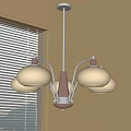 Modern Chandelier Featuring White Glass Shades Metal Arms and Natural Light Near Window with Blinds