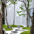 Beautiful Park Landscape With Green Trees Winding Path Grass Stones White Walls And Glass Building