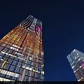 Illuminated Tall Glass Buildings Against Dark Sky Urban Night Landscape View