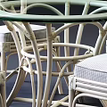 Light Colored Rattan Dining Chairs With Elegant Back Design And Upholstered Seats 3d model