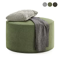 Gray Upholstered Round Ottoman Bench With Yellow Cushion And Gray Knit Blanket