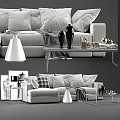 Modern Sofa and Coffee Table Set With Gray Pillows Black Vases and Decorative Items