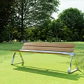 Wooden Outdoor Bench With Metal Frame In Green Grass And Trees Setting