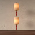 Two White Fabric Hanging Lanterns With Red Tassels On Beige Wall Interior 3d model